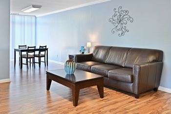 a living room with a leather couch and a coffee table at Fox Run Apartments, St. Charles, Illinois